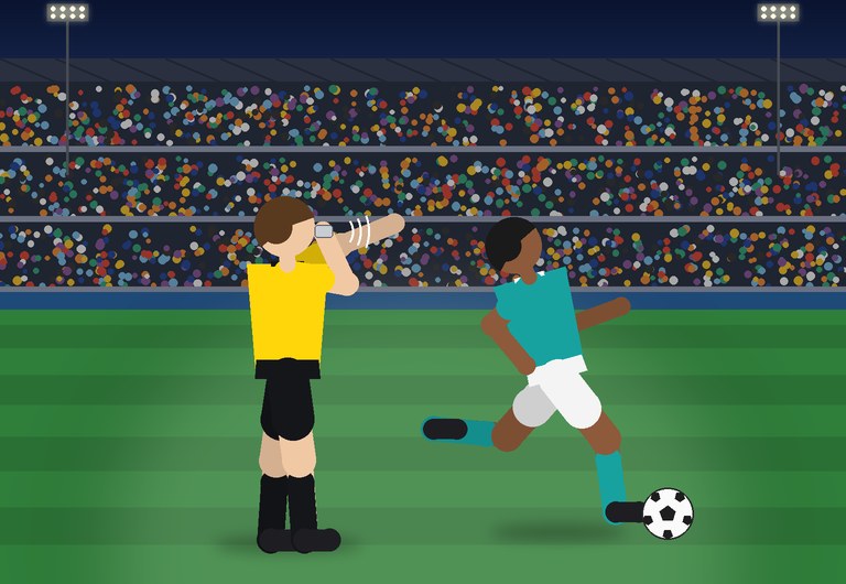 A referee blows the whistle during a night match