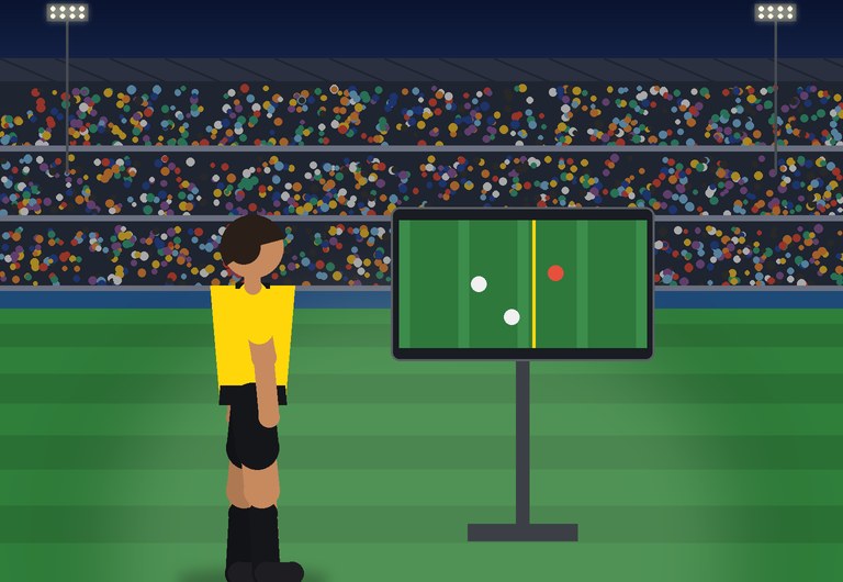 A referee walks to the pitch-side monitor
